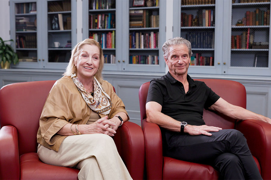 Ellie and Don Knauss sit in red armchairs facing the camera.