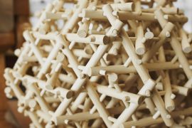 A close-up look at a wooden mechanical puzzle.