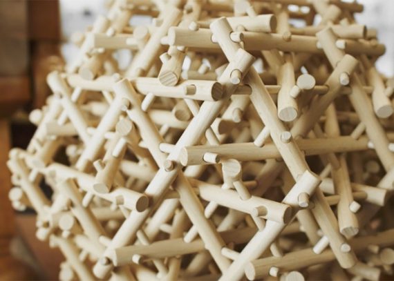 A close-up look at a wooden mechanical puzzle.