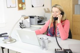 Woman working at home on phone