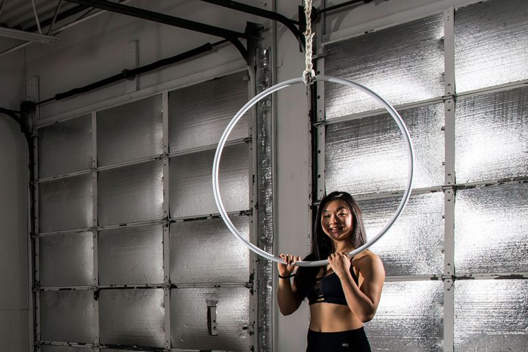 IU student Grace Wang demonstrates the lyra, which is also known as an aerial hoop. It is suspended from above and can be used static or while it's spinning and swinging. Photo by Marc Lebryk.