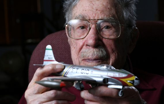 Centenarian Oliver G. Cellini holding a model airplane.