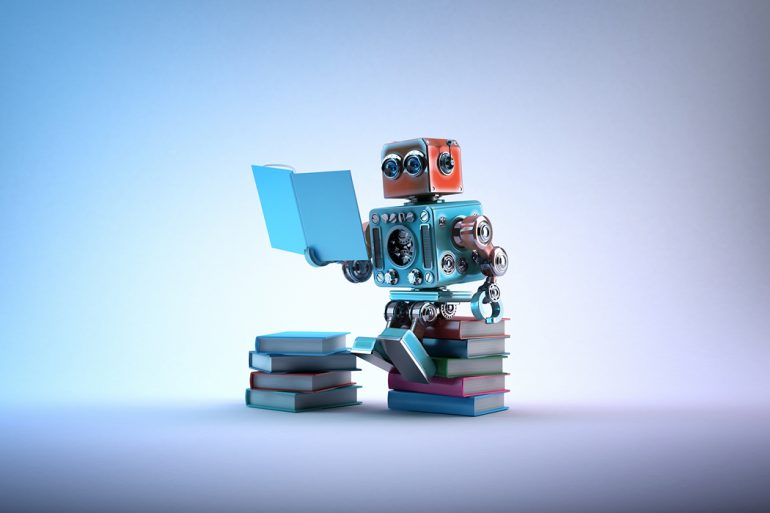 A robot sits and reads on a stack of books