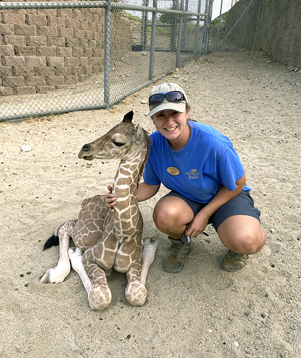 Caroline Fischer poses with baby giraffe at The Living Desert Zoo and Gardens