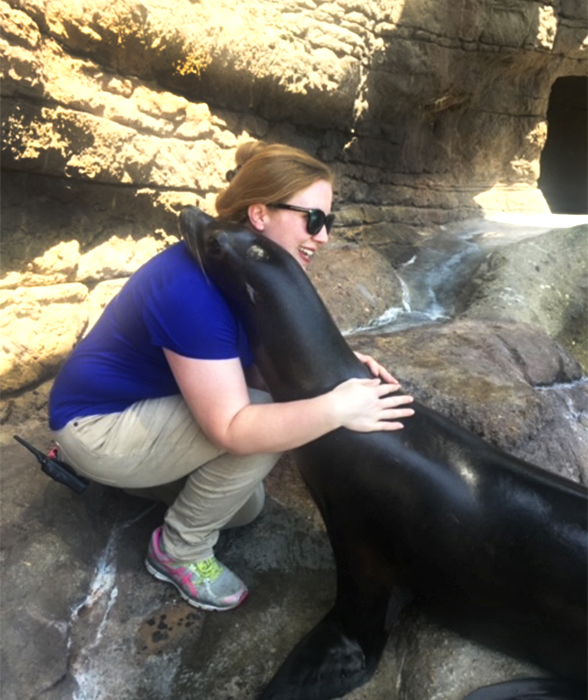 Sarah Hoback hugging a seal at the Newport Aquarium