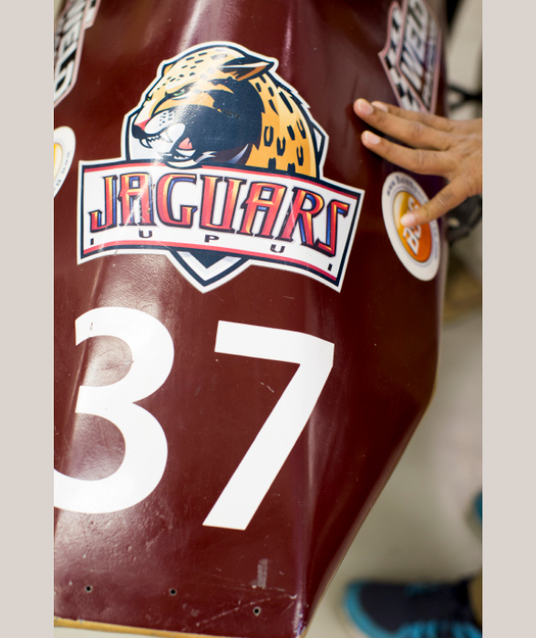 Close up on the nose of a race car. The body is maroon with a large number 37 on it and the IUPUI Jaguars logo.