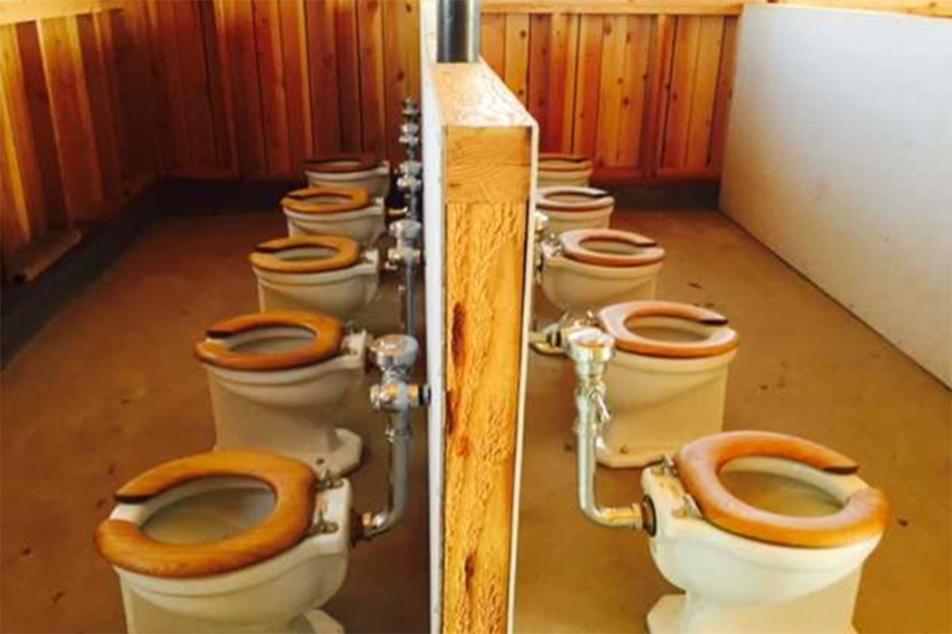Row of toilets in Manzanar barracks replica