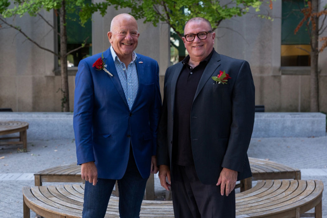 Steve Tuchman and husband Reed Bobrick wear suits