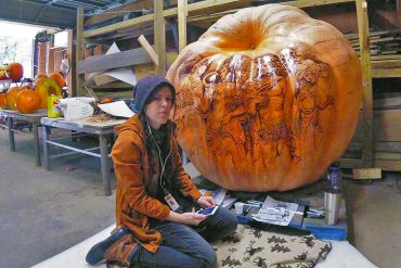 Amie Villiger Harris in front of a 1,450-pound pumpkin