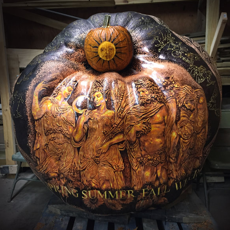 Carved 1,450-pound pumpkin depicting the four seasons