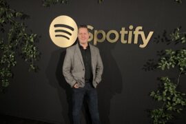 Jon Cohen in front of a Spotify sign