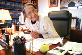 Viola Taliaferro sits at her office desk