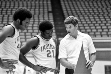 Coach Bob Knight stands with two players